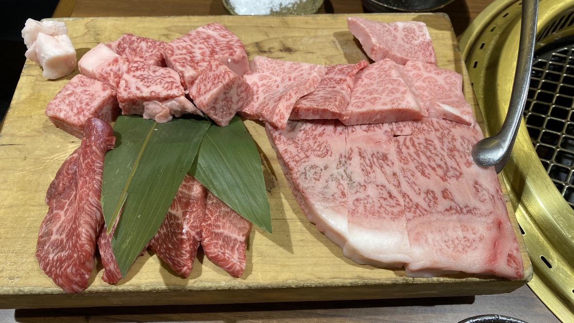 Marbled Hida beef arranged on a wooden serving board